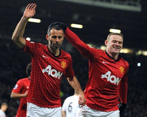 Manchester United's Ryan Giggs (L) celebrates with Wayne Rooney January 26, 2013